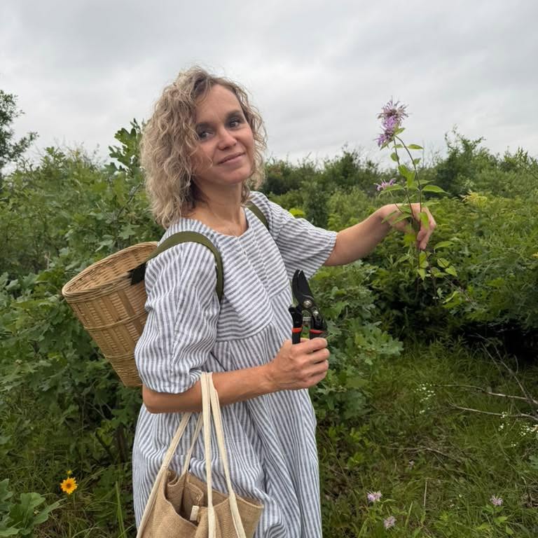 Alena gathering herbs in nature